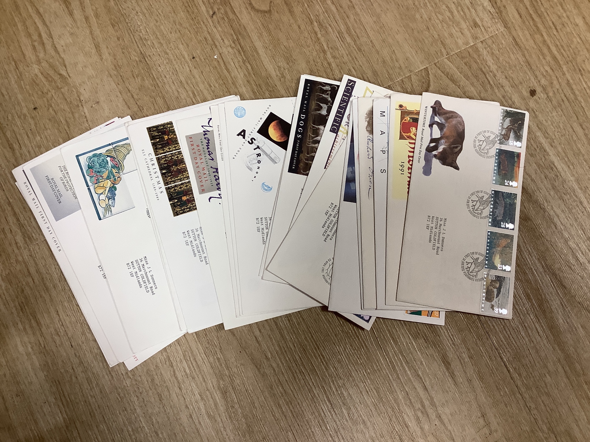 A postcard album, 10 assorted medals postcards and silks and first day covers